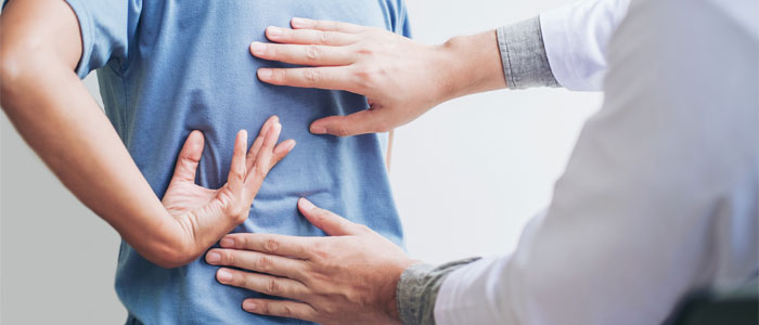 chiropractor evaluating scoliosis patient